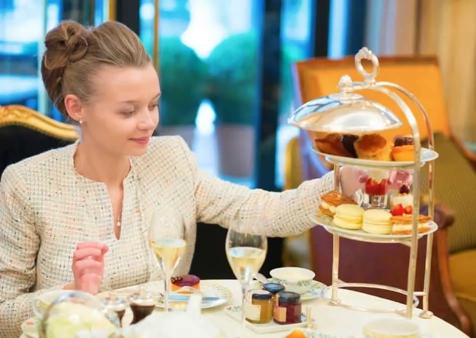 what is afternoon tea? A woman enjoying traditional afternoon tea