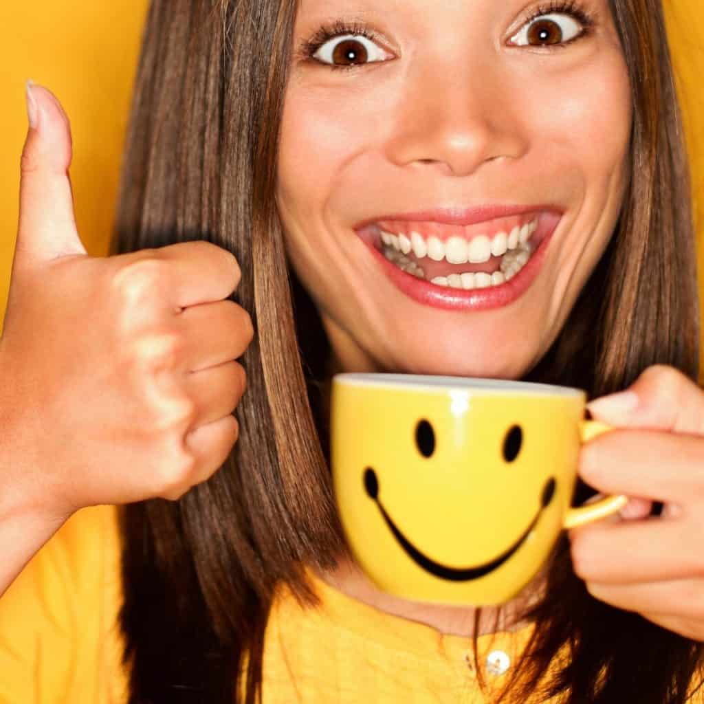 smiling girl with cup of caffeinated tea