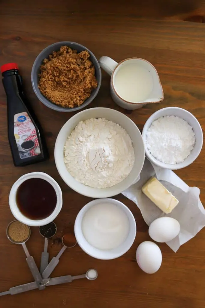 ingredients for chai cinnamon rolls on a wood background
